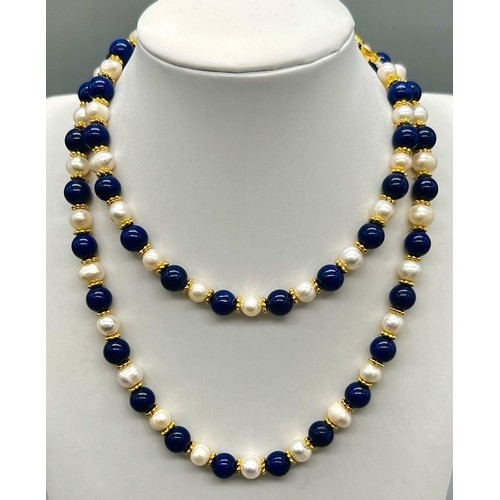 319 - A Lapis Lazuli and Cultured Pearl Matinee Length Necklace. 8mm lapis and pearls. Gilded spacers and ... 