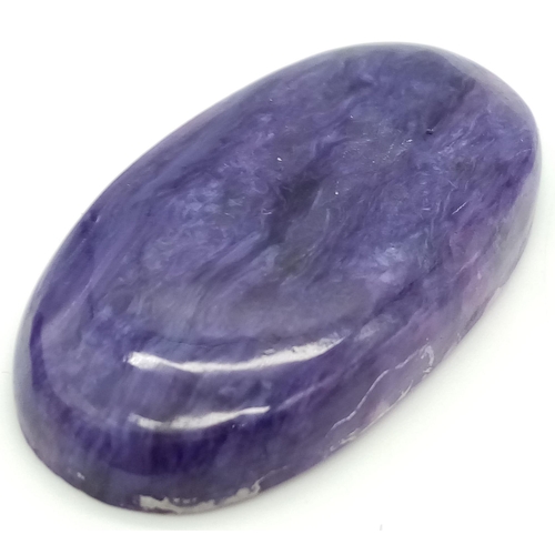 126 - A rare and beautiful, high quality, large (50 carats), natural CHAROITE. Highly polished, oval caboc... 