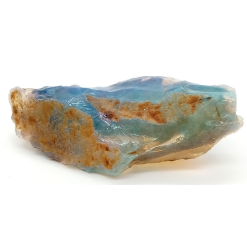 140 - A large (429.20 carats!), natural, rough opal, with mainly blue, green and yellow hues, semi-translu... 