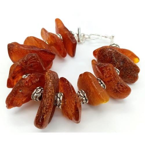 210 - An interesting Tibetan silver and Baltic amber natural bracelet. Length: 19-22 cm, weight: 56 g