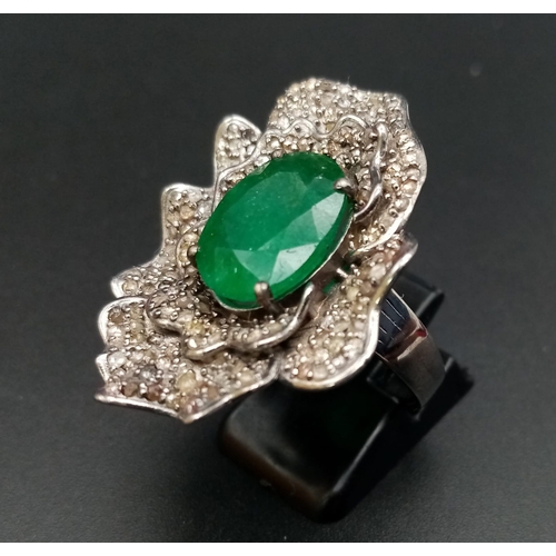 398 - A 6ct Oval Cut Emerald Gemstone Ring with 2.20ct of Diamond Floral Accents. Set in 925 Silver. Size ... 