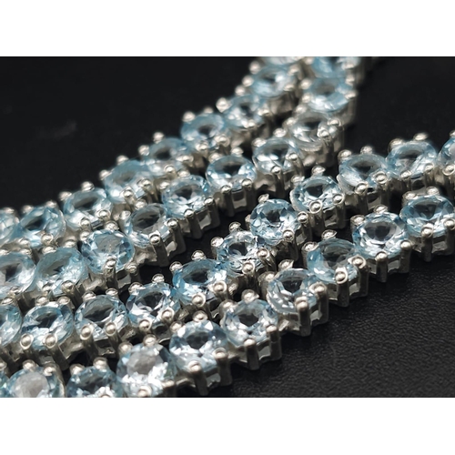 405 - A Blue Topaz Gemstone Tennis Necklace set in 925 Silver. 46cm. 33g total weight.