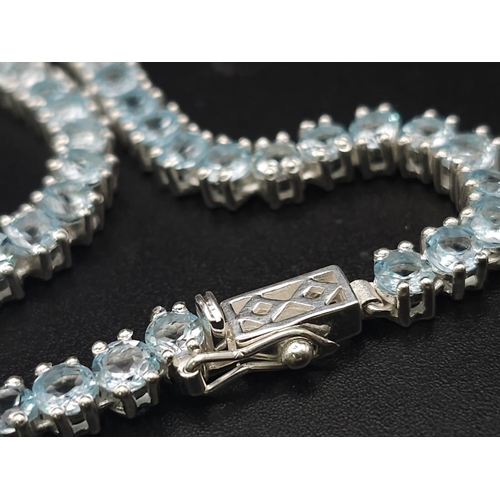 405 - A Blue Topaz Gemstone Tennis Necklace set in 925 Silver. 46cm. 33g total weight.