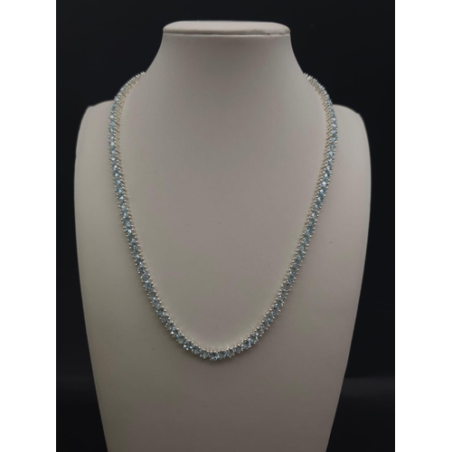 405 - A Blue Topaz Gemstone Tennis Necklace set in 925 Silver. 46cm. 33g total weight.