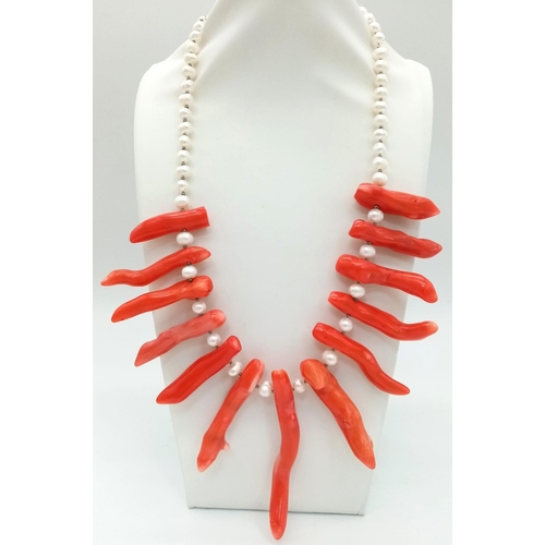 196 - A statement necklace and earrings set with genuine red corals and natural, cultured white pearls. Co... 