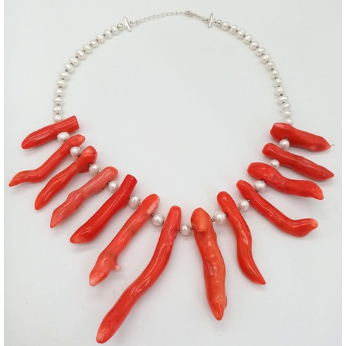 196 - A statement necklace and earrings set with genuine red corals and natural, cultured white pearls. Co... 