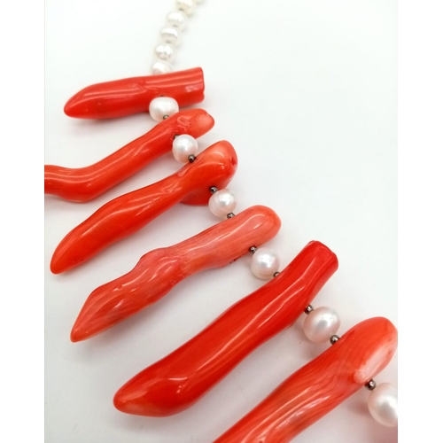 196 - A statement necklace and earrings set with genuine red corals and natural, cultured white pearls. Co... 