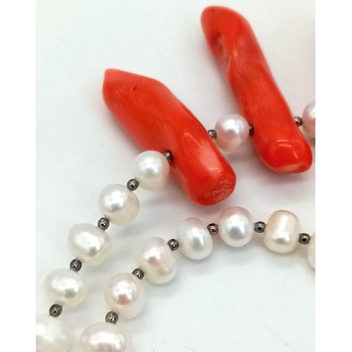 196 - A statement necklace and earrings set with genuine red corals and natural, cultured white pearls. Co... 