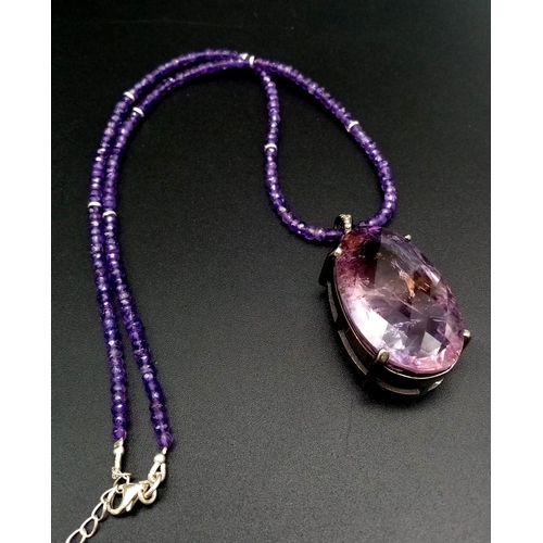 330 - A 71ct Amethyst Large Oval Gemstone Pendant with 0.15ct Diamond Accents on its Attachment Loop. Come... 