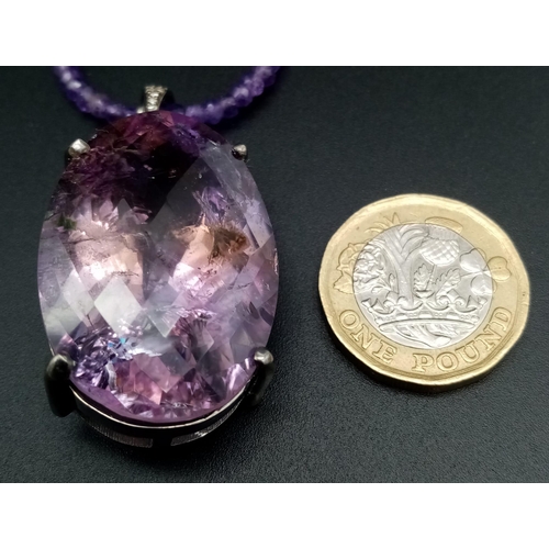 330 - A 71ct Amethyst Large Oval Gemstone Pendant with 0.15ct Diamond Accents on its Attachment Loop. Come... 