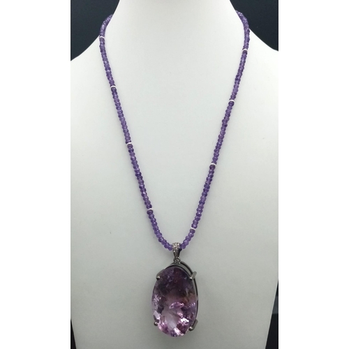 330 - A 71ct Amethyst Large Oval Gemstone Pendant with 0.15ct Diamond Accents on its Attachment Loop. Come... 