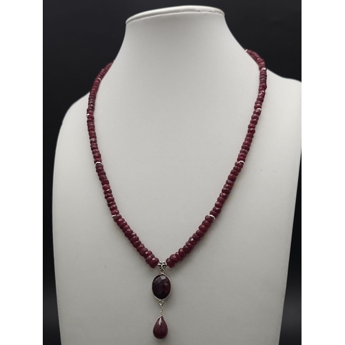 433 - A 120ct Ruby Bead Gemstone Necklace with a Ruby Drop Pendant. 3/4mm beads. 3cm and 42cm.