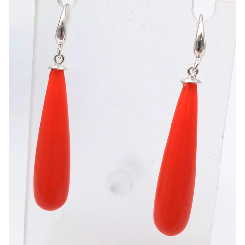 318 - A Carved Red Coral Bead Necklace and Drop Earrings. Beads - 15mm. Necklace - 48cm. Earrings 3.5cm dr... 