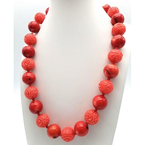 318 - A Carved Red Coral Bead Necklace and Drop Earrings. Beads - 15mm. Necklace - 48cm. Earrings 3.5cm dr... 