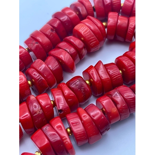 478 - A Red Rondelle Bead Coral Necklace with a Lakshmi Gilded Pendant - 4cm. Necklace - 42cm.