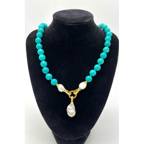 352 - An Exquisite Blue Turquoise and Baroque Pearl Necklace. 10mm turquoise beads lead to a Baroque Drop!... 