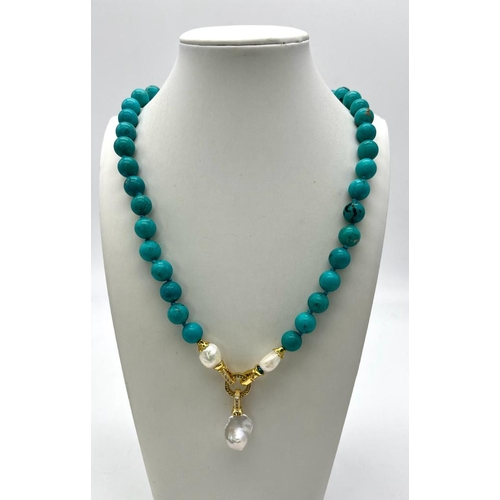 352 - An Exquisite Blue Turquoise and Baroque Pearl Necklace. 10mm turquoise beads lead to a Baroque Drop!... 