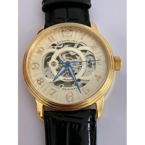 28 - Gentlemans AUTOMATIC SKELETON WRISTWATCH from MAX STUHRLING of NEW YORK. Finished in gold tone and h... 