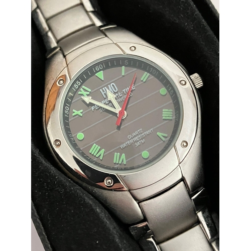 420 - HMO SOLAR POWERED WRISTWATCH Finished in stainless steel with attractive green digits and a sweeping... 