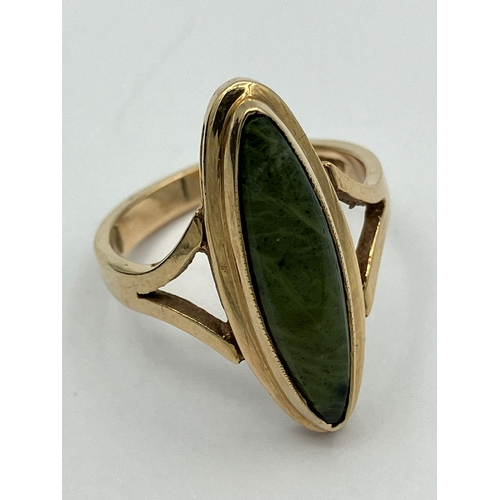 98 - 9 carat GOLD and MALACHITE RING, having polished Marquise shape Malachite gemstone set in an attract... 