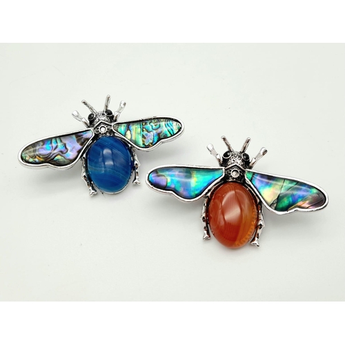 394 - Two Gemstone Bee Brooches - Lapis and Carnelian. Decorative shell Wings. 5.5cm wingspan. Set in whit... 