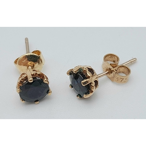 423 - A Pair of 9K Yellow Gold and Sapphire Stud Earrings. 1.38g total weight.