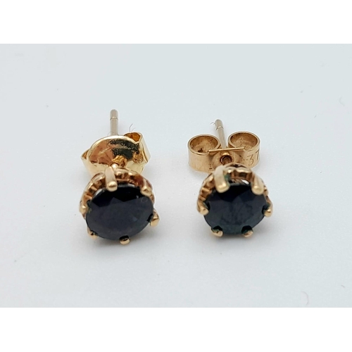 423 - A Pair of 9K Yellow Gold and Sapphire Stud Earrings. 1.38g total weight.