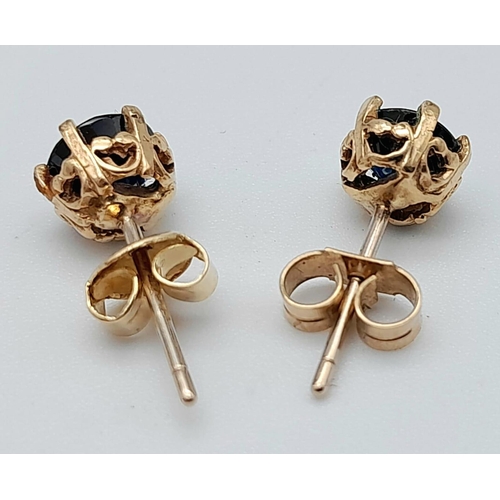 423 - A Pair of 9K Yellow Gold and Sapphire Stud Earrings. 1.38g total weight.