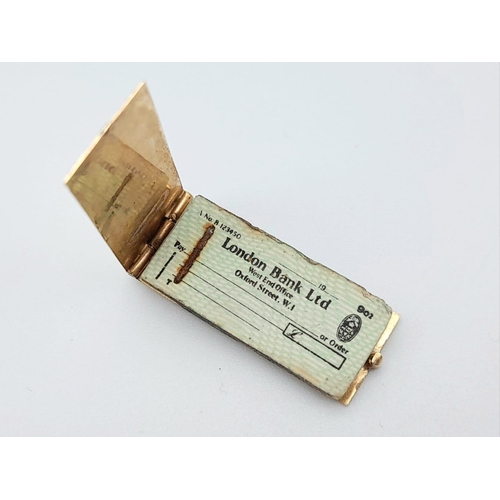 455 - 9K YELLOW GOLD LONDON BANK LTD CHEQUE BOOK CHARM / PENDANT OPENS TO REVEAL A PAPER CHEQUE 2.6G