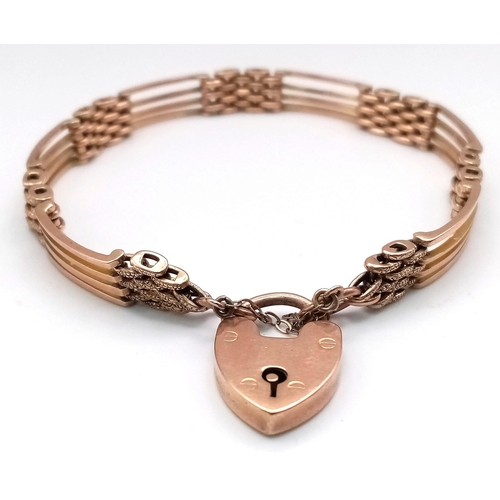 115 - AN ANTIQUE ROSE GOLD GATE BRACELET IN 9K GOLD WITH HEART PADLOCK .   17.6gms