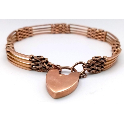 115 - AN ANTIQUE ROSE GOLD GATE BRACELET IN 9K GOLD WITH HEART PADLOCK .   17.6gms