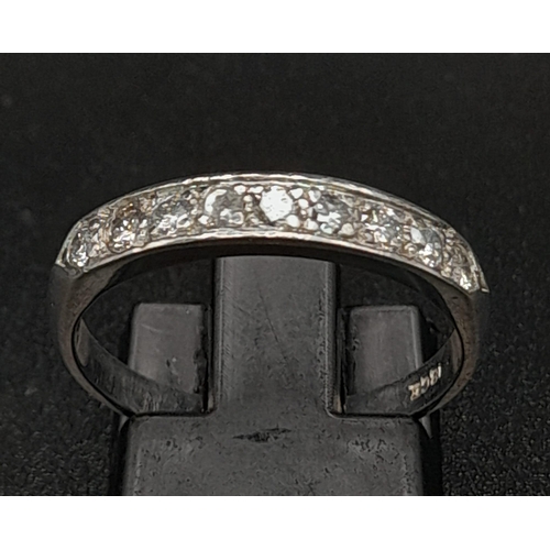 215 - 18K WHITE GOLD DIAMOND 1/2 ETERNITY RING.  0.30CT DIAMOND. TOTAL WEIGHT 2.9G.  SIZE N 1/2