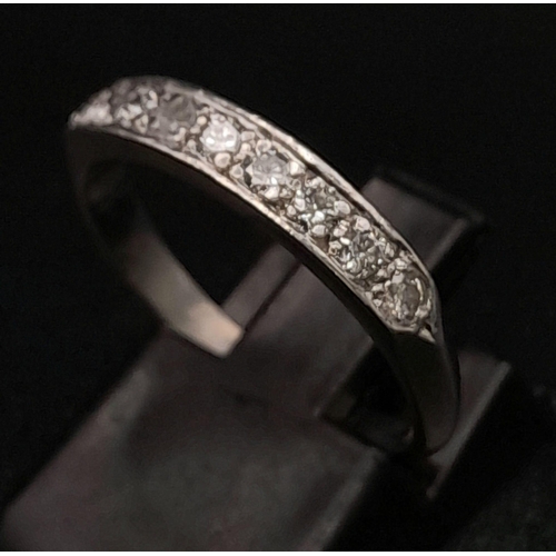 215 - 18K WHITE GOLD DIAMOND 1/2 ETERNITY RING.  0.30CT DIAMOND. TOTAL WEIGHT 2.9G.  SIZE N 1/2