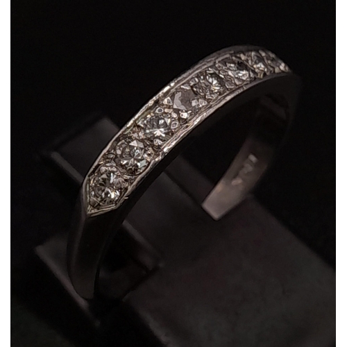 215 - 18K WHITE GOLD DIAMOND 1/2 ETERNITY RING.  0.30CT DIAMOND. TOTAL WEIGHT 2.9G.  SIZE N 1/2