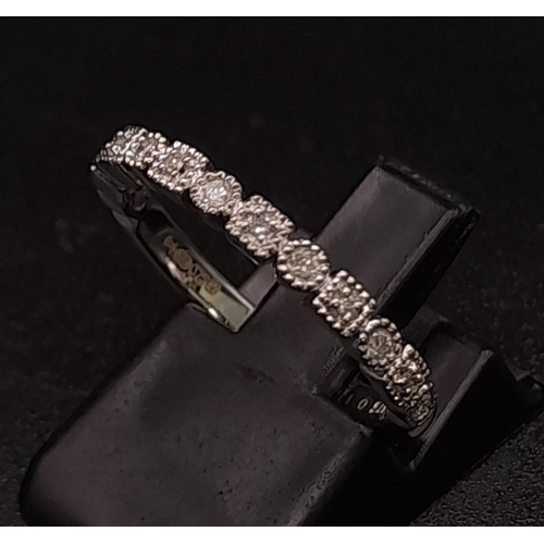 264 - 9K WHITE GOLD DIAMOND BAND RING. TOTAL WEIGHT 2.44G. SIZE L