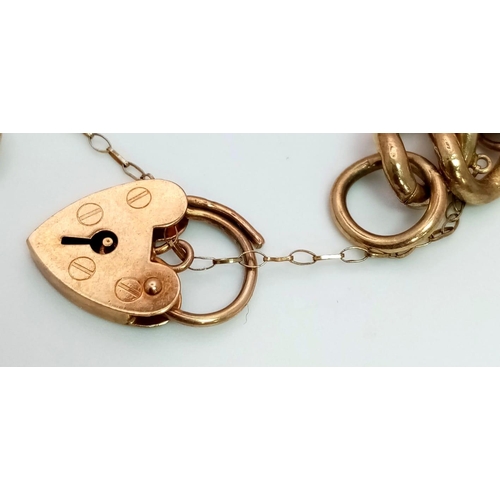 30 - A VINTAGE 9K GOLD CHARM BRACELETWITH HEART PADLOCK PLUS 6 INTERESTING CHARMS TO INCLUDE , A CLOWN , ... 