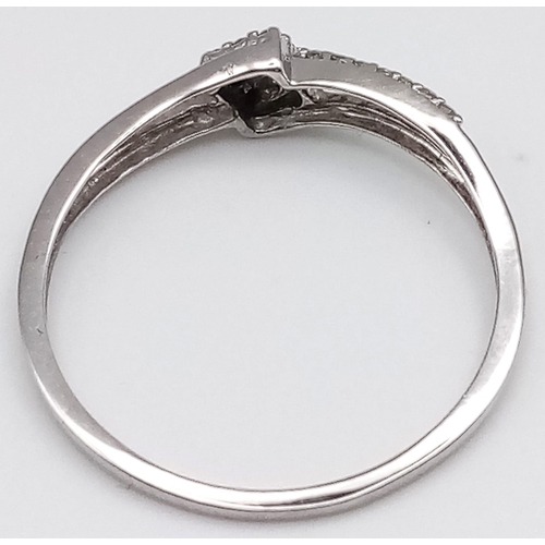 496 - 9K WHITE GOLD DIAMOND SPLIT SHANK TWIST RING.  0.15CT DIAMOND. TOTAL WEIGHT 1.2G.  SIZE Q 1/2