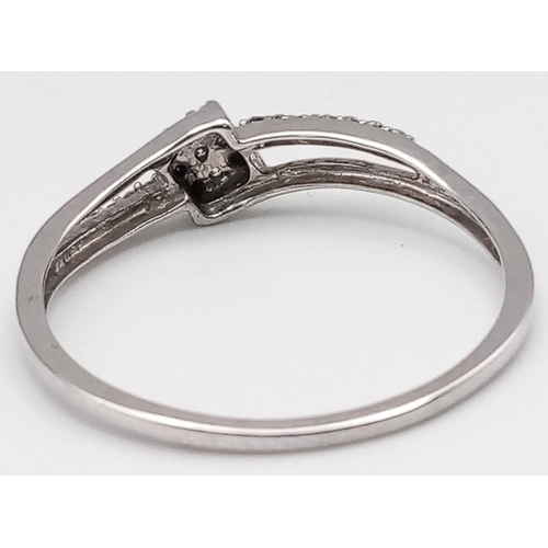 496 - 9K WHITE GOLD DIAMOND SPLIT SHANK TWIST RING.  0.15CT DIAMOND. TOTAL WEIGHT 1.2G.  SIZE Q 1/2