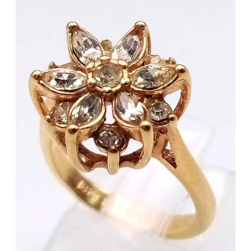 178 - A VERY PRETTY STONE SET 18K GOLD RING IN FLORAL FORM.   3.1gms   size J