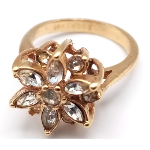 178 - A VERY PRETTY STONE SET 18K GOLD RING IN FLORAL FORM.   3.1gms   size J