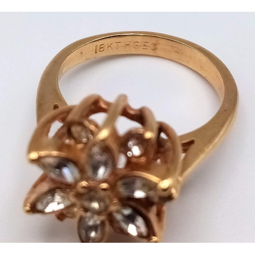 178 - A VERY PRETTY STONE SET 18K GOLD RING IN FLORAL FORM.   3.1gms   size J