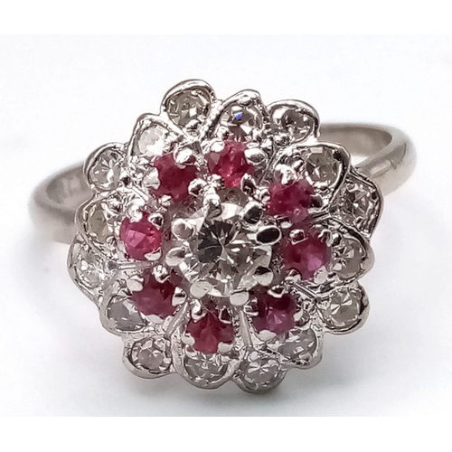 229 - 18K WHITE GOLD DIAMOND & RUBY CLUSTER RING.  0.35CT DIAMOND. TOTAL WEIGHT 3.8G.  SIZE N