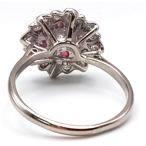 229 - 18K WHITE GOLD DIAMOND & RUBY CLUSTER RING.  0.35CT DIAMOND. TOTAL WEIGHT 3.8G.  SIZE N