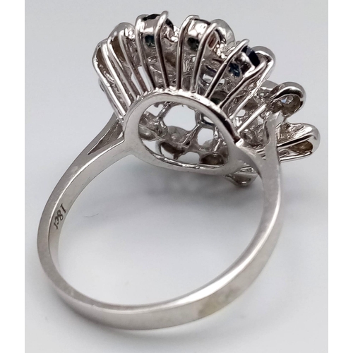 347 - An 18K White Gold Diamond and Sapphire Floral Burst Ring. Size O 1/2. 6.75g total weight.