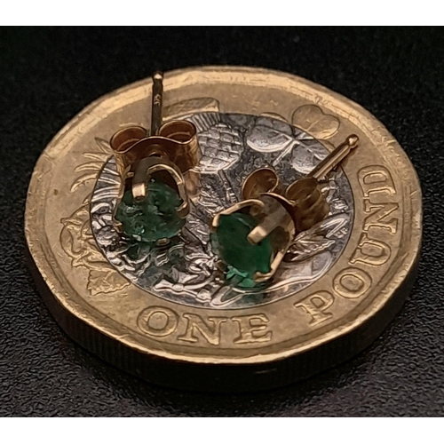 416 - A Pair of 9K Yellow Gold Emerald Stud Earrings. 0.5g total weight.