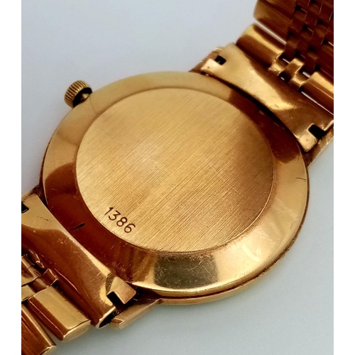 52 - A 9K GOLD ROTARY GENTS QUARTZ WATCH ON A SOLID 9K GOLD STRAP , FULL WORKING ORDER ,34mm  TOTAL WEIGH... 