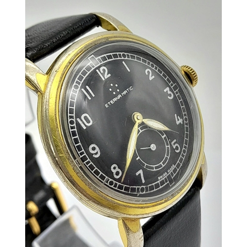 156 - A Vintage Eterna-Matic Gents Watch. Black leather strap. Two-tone case - 34mm. Black dial with secon... 