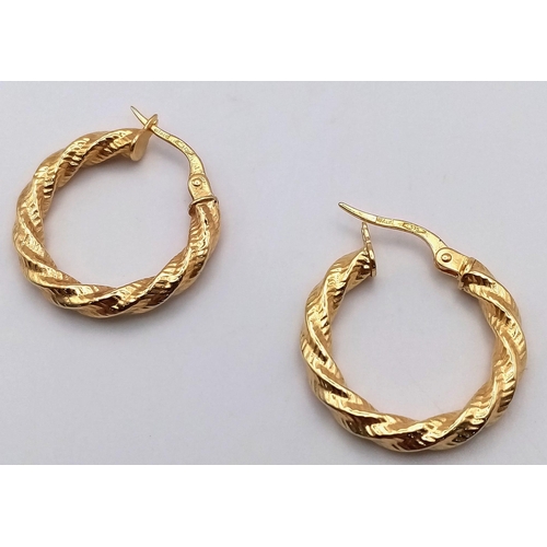 214 - A PAIR OF 9K GOLD BARKED HOOP EARRINGS . 1.1gms