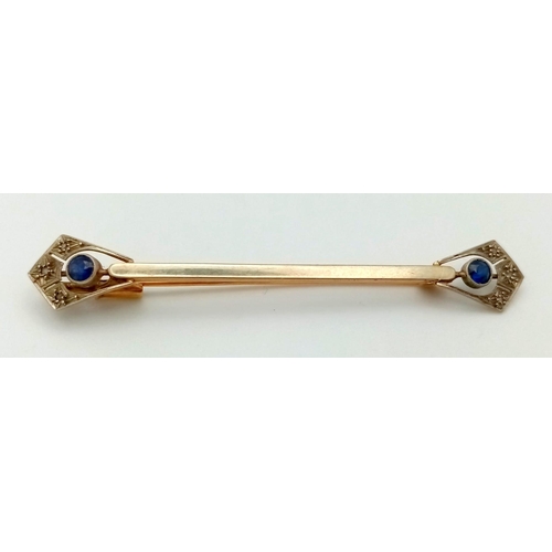 393 - An Antique 18K Gold and Sapphire Bar Brooch. Anglicanesque sapphire ends. 6cm. 2.7g total weight