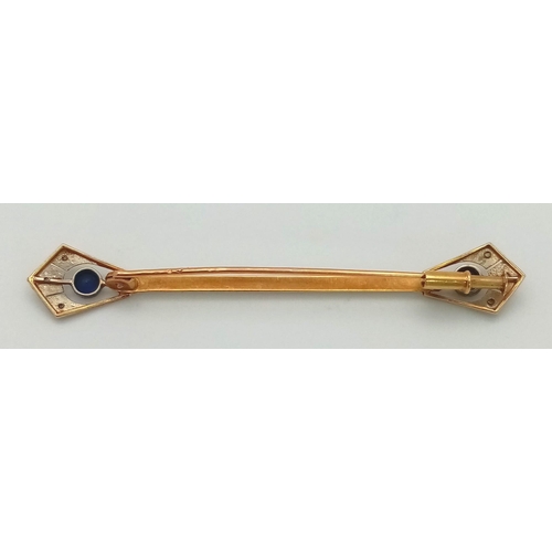 393 - An Antique 18K Gold and Sapphire Bar Brooch. Anglicanesque sapphire ends. 6cm. 2.7g total weight